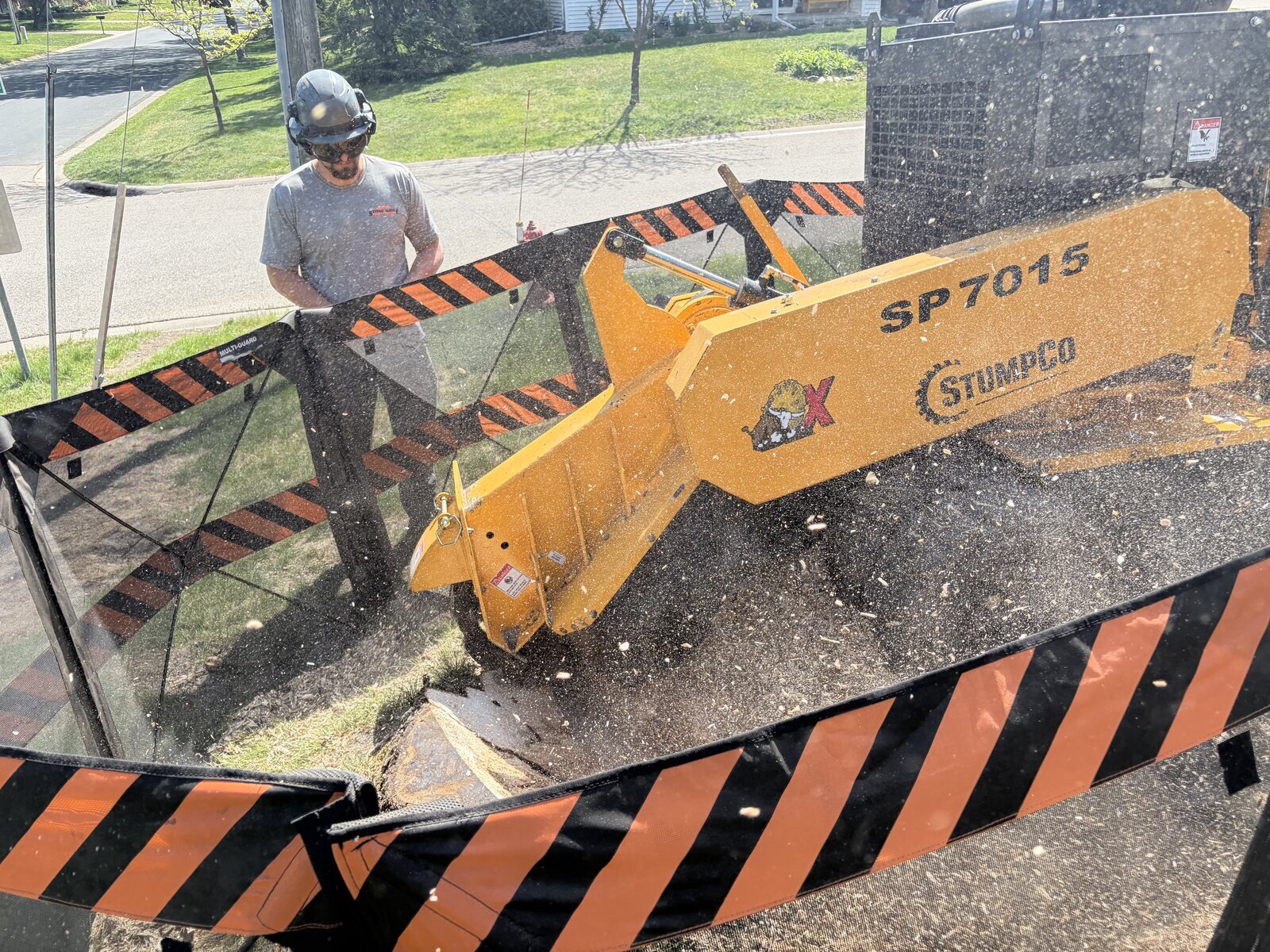 StumpCo grinding a stump on a residential property